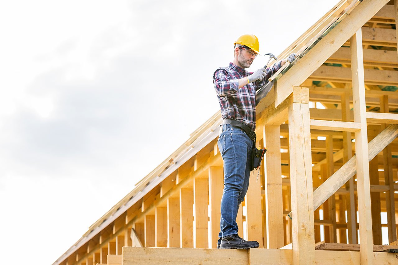 Man working on house framing